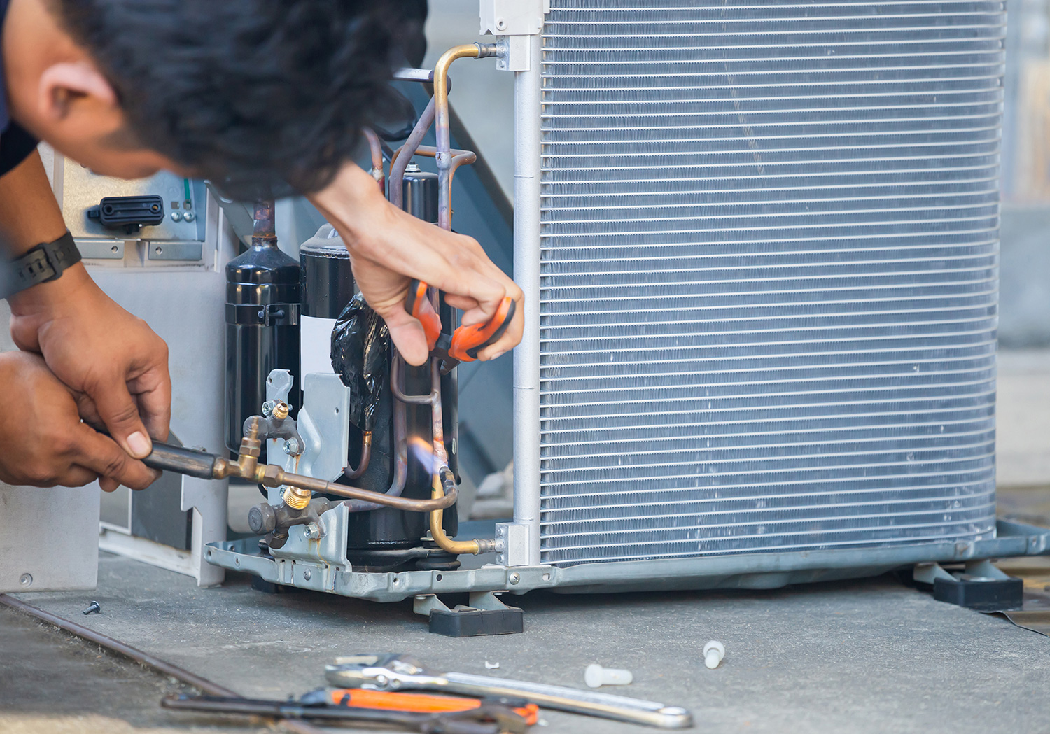 image of a technician working on a HVAC unit