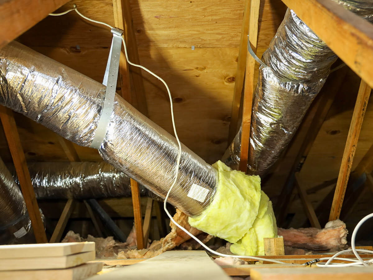 view of fiber glass duct for central air in an attic