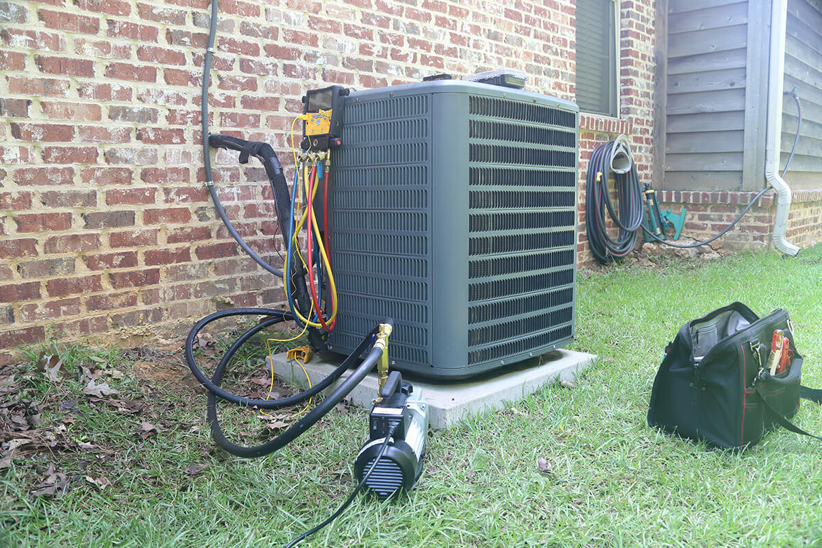 HVAC testing equipment hooked up to an air conditioning unit