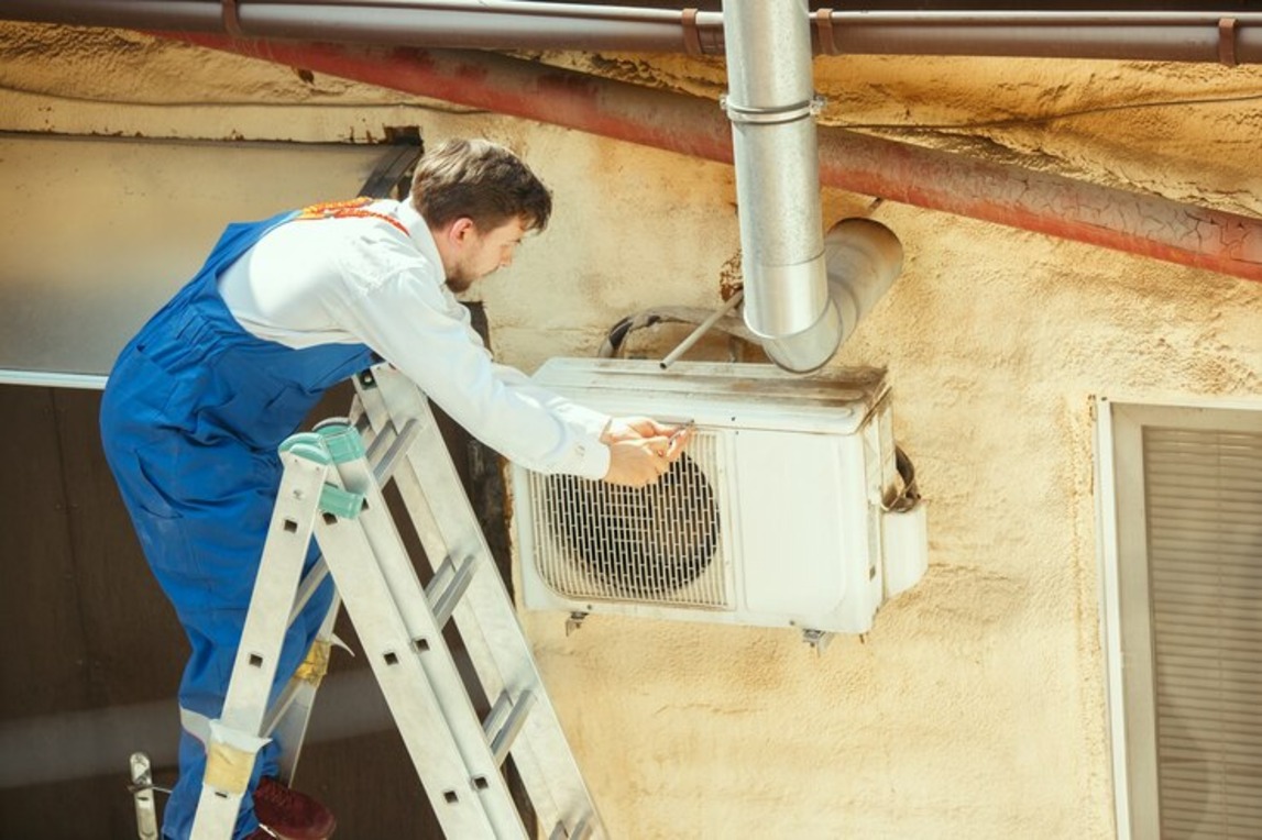 Person doing Proper Insulation for HVAC Efficiency and maintenance